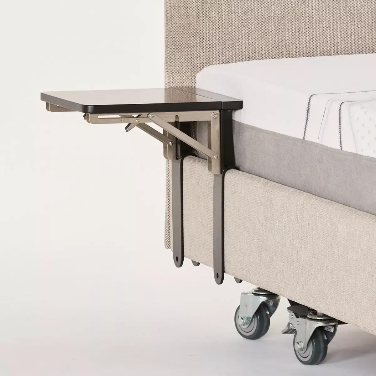 Icare fold down tray table mounted to a bed frame